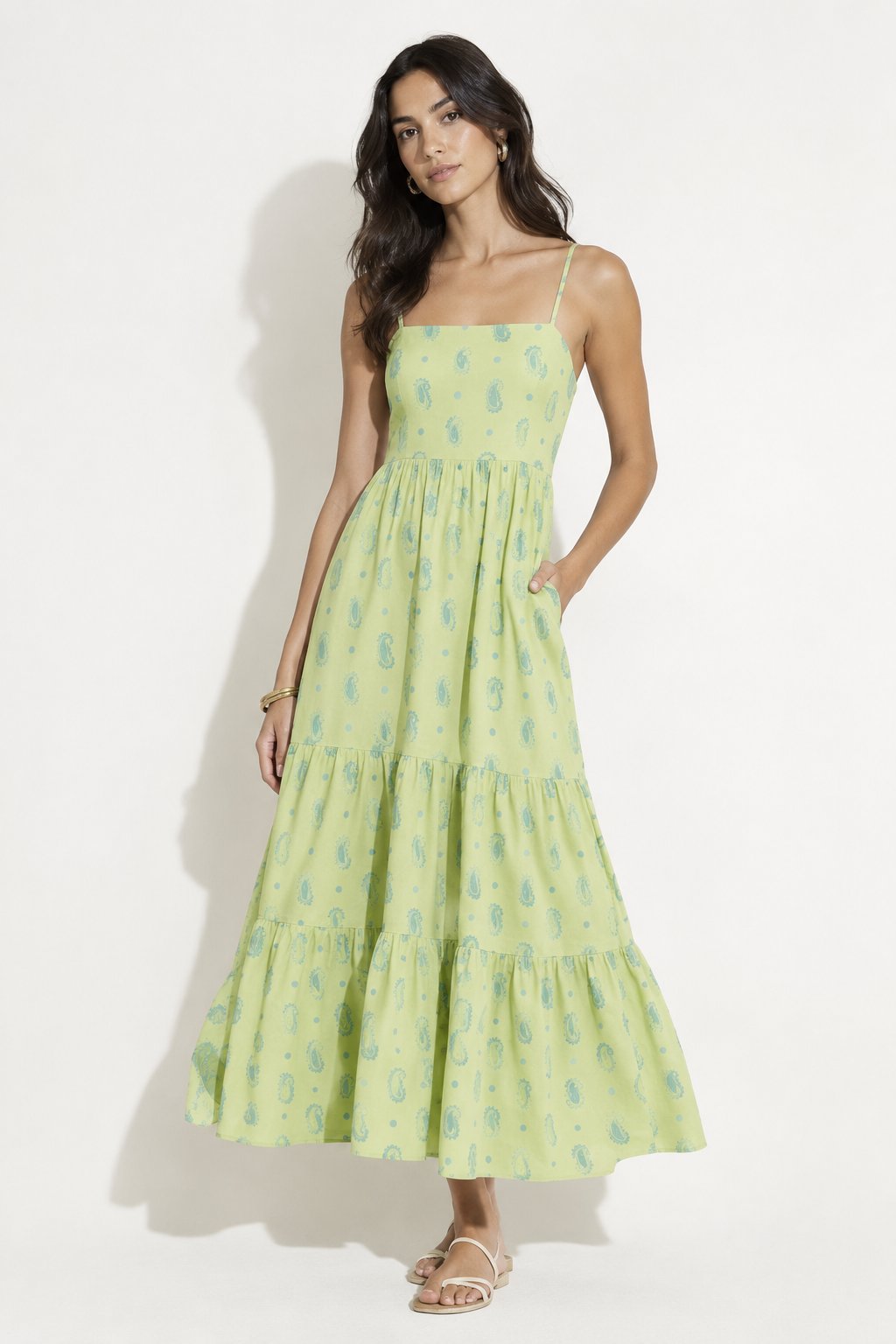 Model wearing a pale green paisley dress