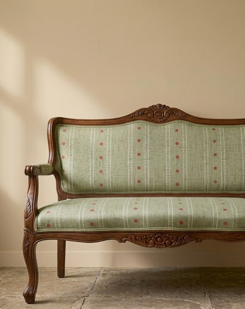 Sage patterned upholstery on a wooden chair