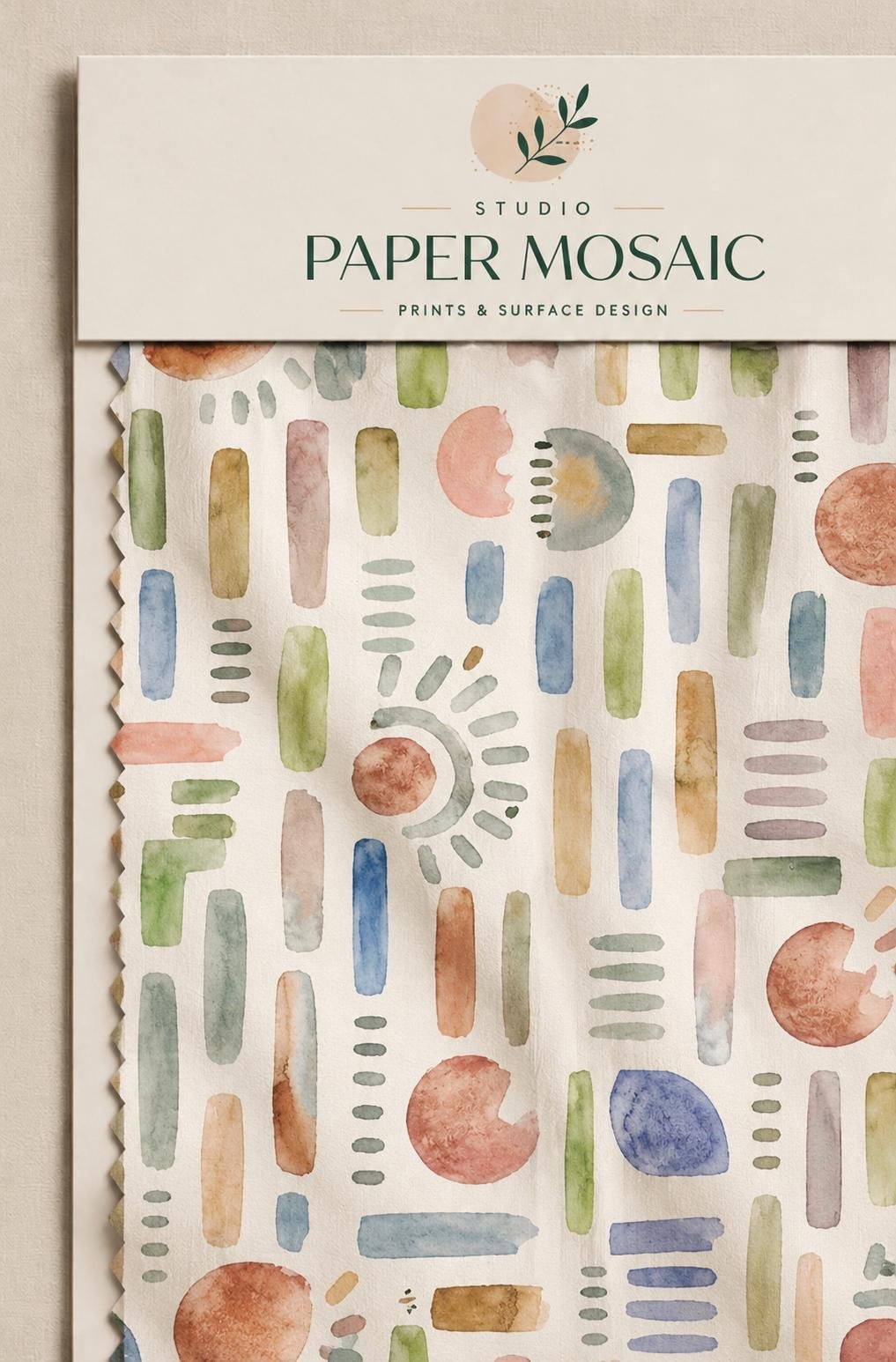 Watercolour geometric shapes in peach, sage and blue on an ivory textile
